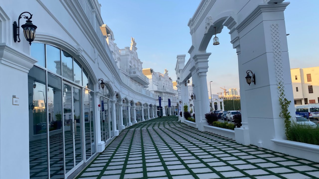 Walking path leading to Vincitore Boulevard Dubai at sunset